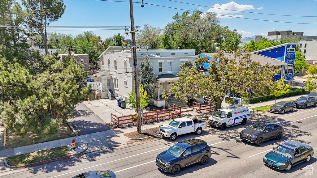 View of asphalt street with sidewalks, curbs, and street lighting