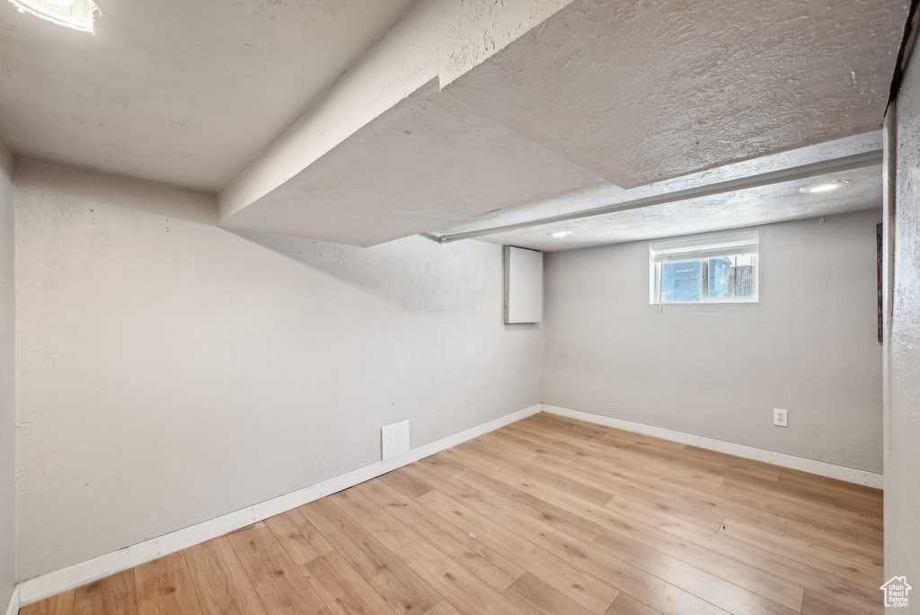 Below grade area featuring wood finished floors and baseboards