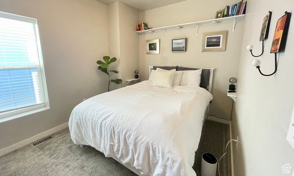 Carpeted bedroom featuring baseboards