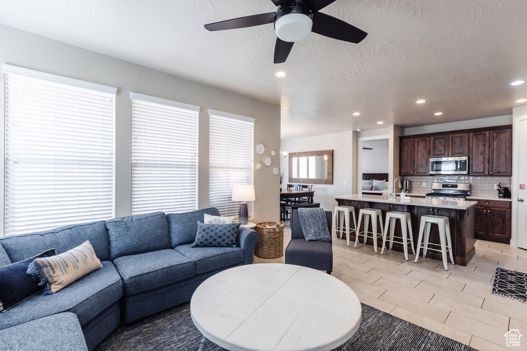 Living room featuring recessed lighting and ceiling fan