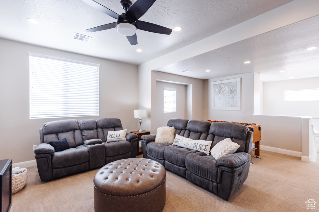 Living room with light colored carpet, recessed lighting, baseboards, and a ceiling fan