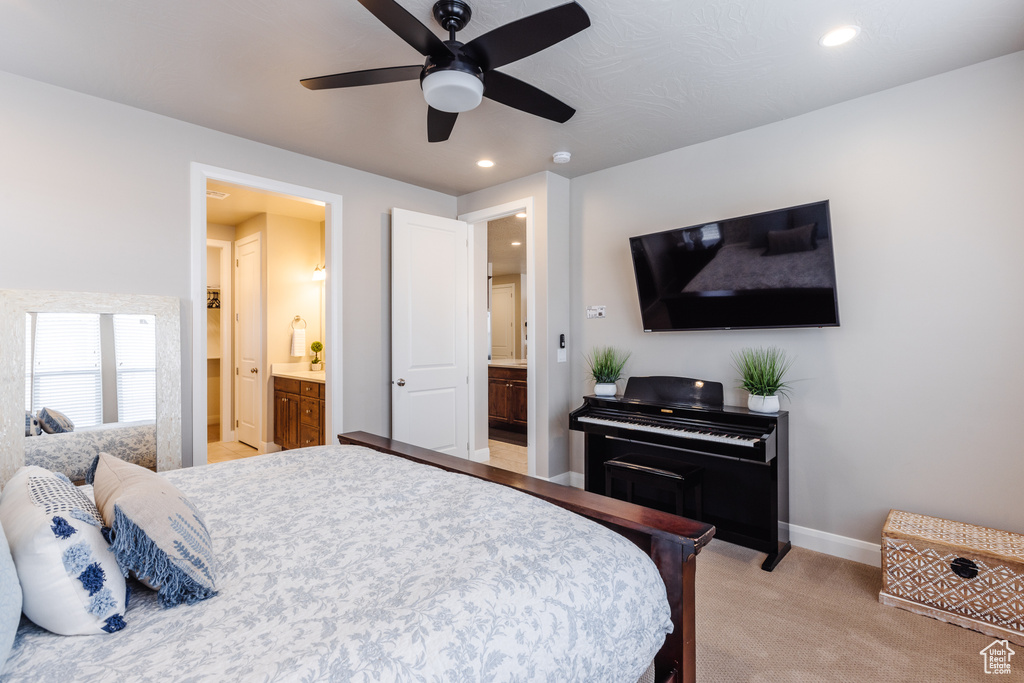 Bedroom with light carpet, ensuite bath, recessed lighting, baseboards, and a ceiling fan