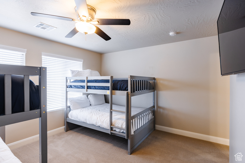 Bedroom featuring carpet flooring, baseboards, and a ceiling fan