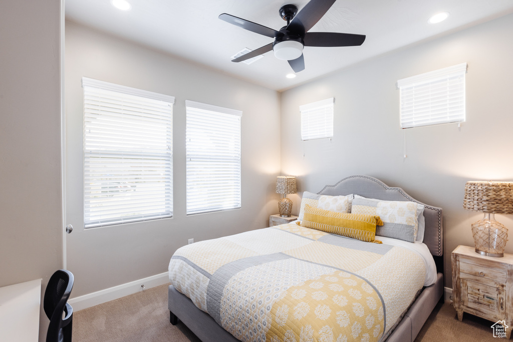 Bedroom featuring light carpet, recessed lighting, baseboards, and a ceiling fan