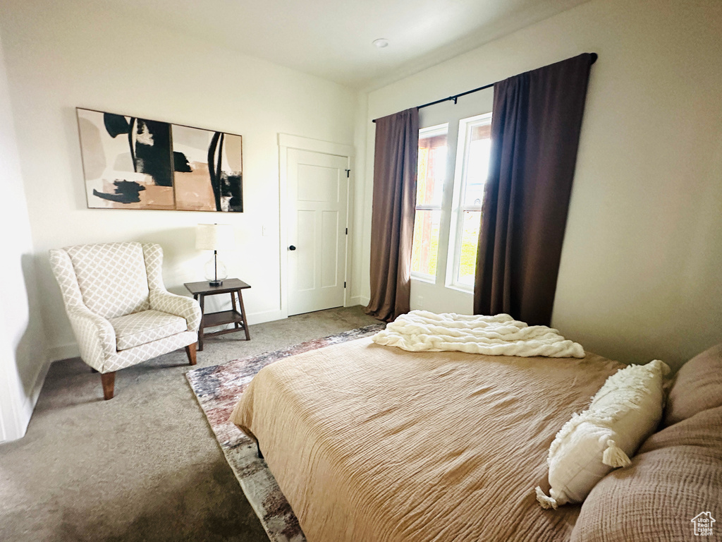 Bedroom with carpet flooring and baseboards