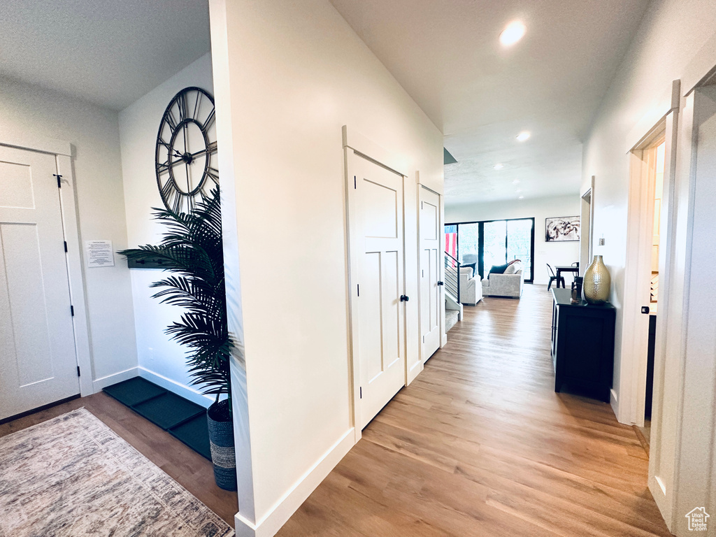 Entrance foyer with light wood finished floors, recessed lighting, and baseboards