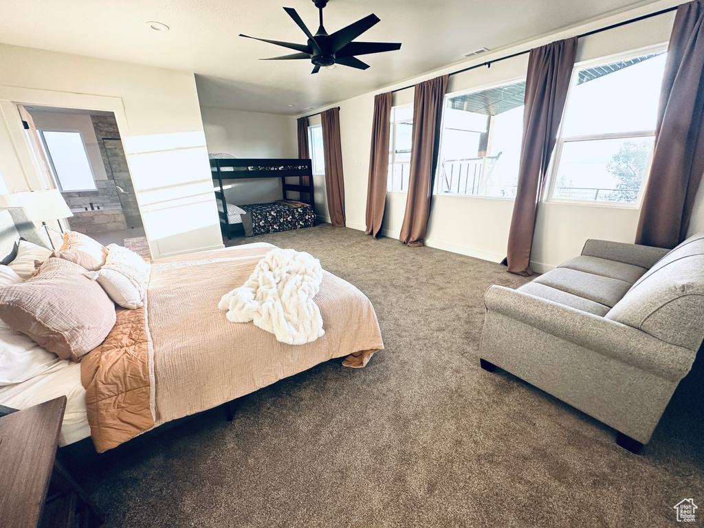 Bedroom with carpet flooring, multiple windows, baseboards, and a ceiling fan