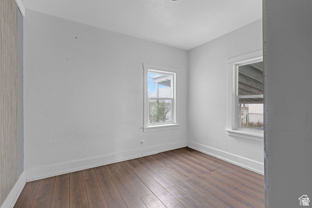 Unfurnished room featuring baseboards and hardwood / wood-style floors