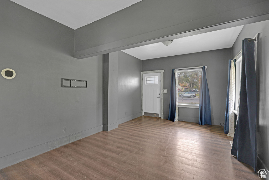 Foyer entrance with wood finished floors and baseboards