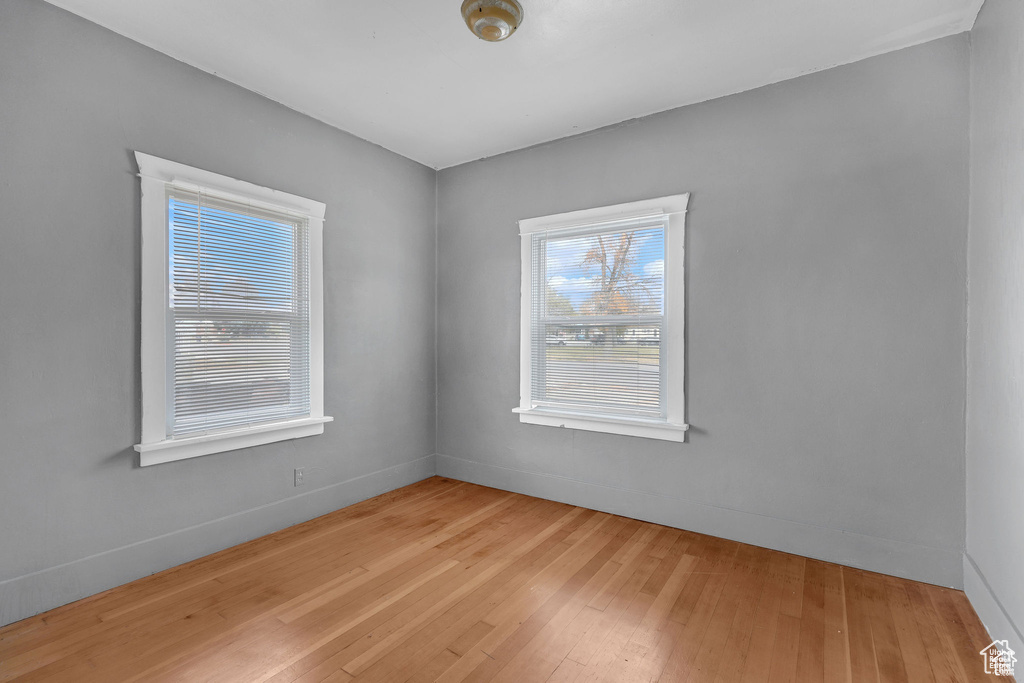 Spare room featuring hardwood / wood-style flooring and baseboards