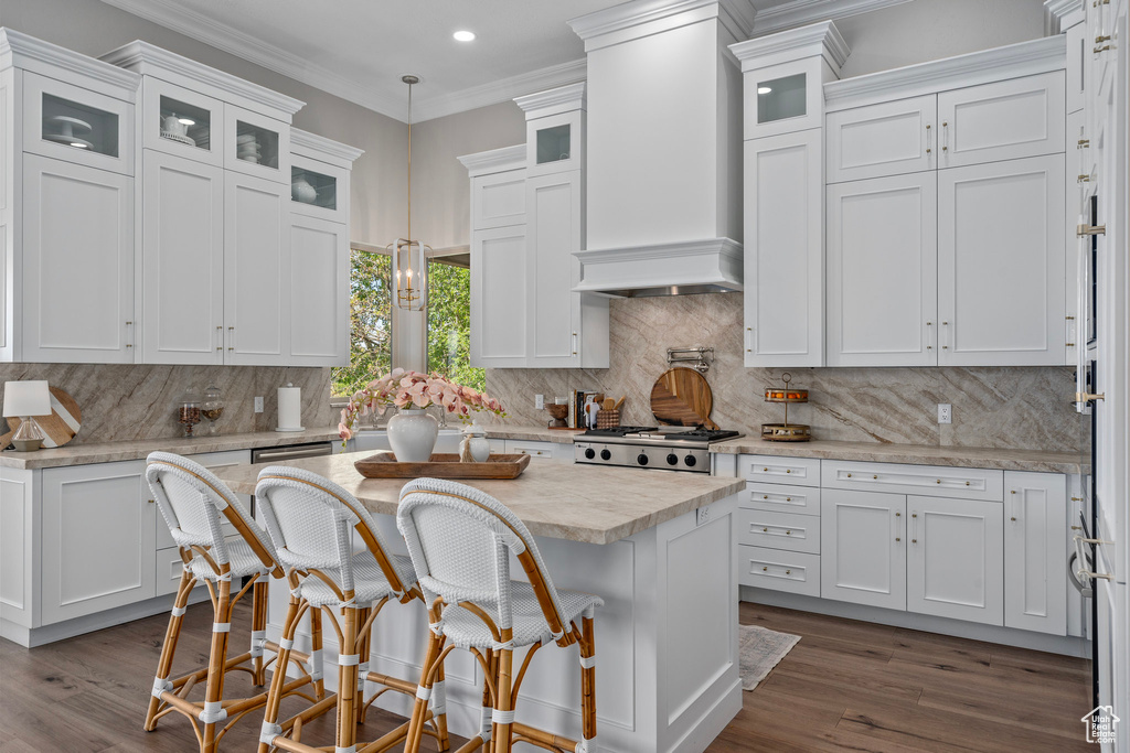 Kitchen featuring white cabinetry, dark wood finished floors, backsplash, premium range hood, and recessed lighting
