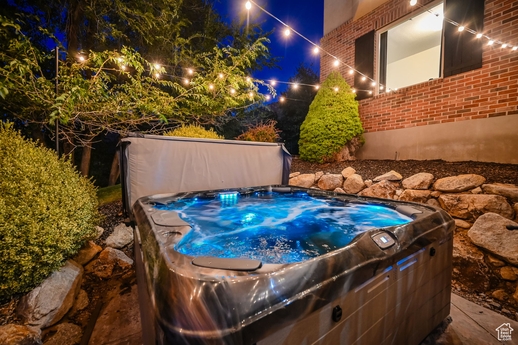 Pool at night with a hot tub