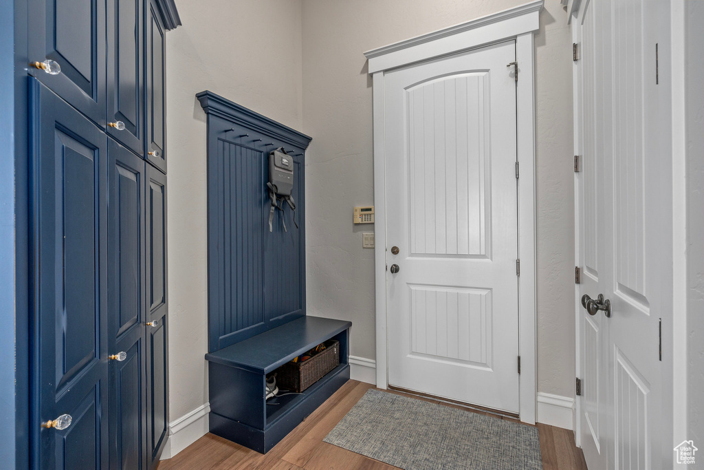 Mudroom with wood finished floors and baseboards