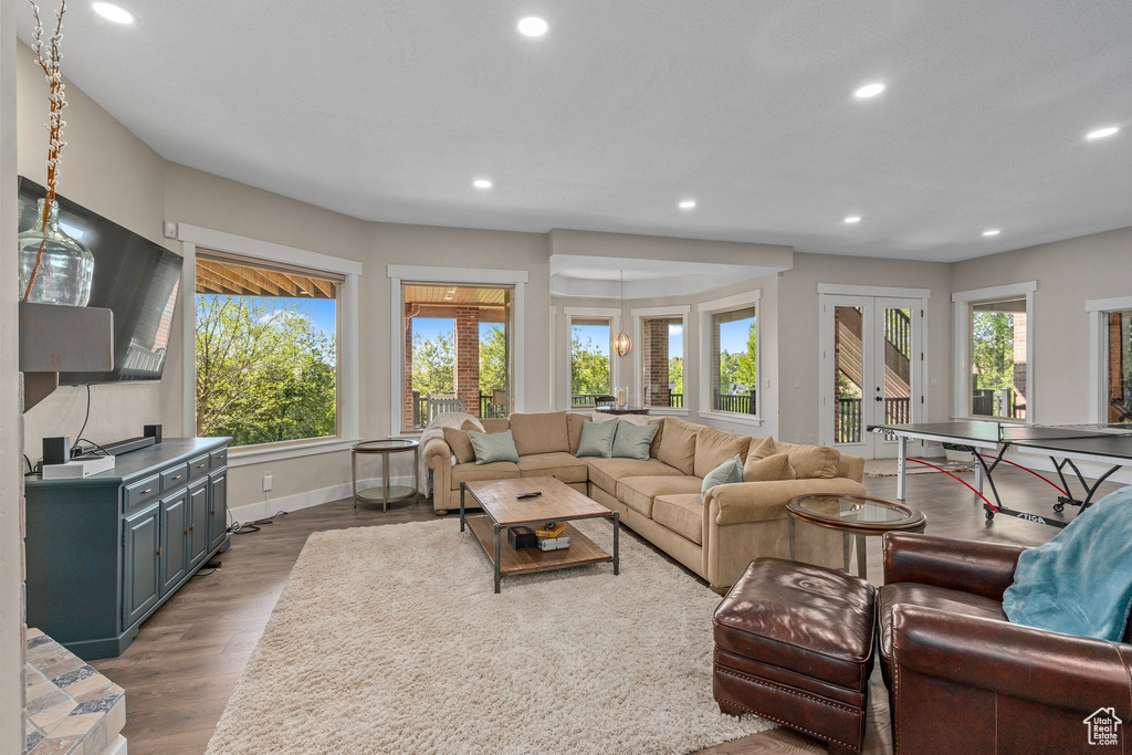 Living area featuring recessed lighting, french doors, dark wood-type flooring, and baseboards