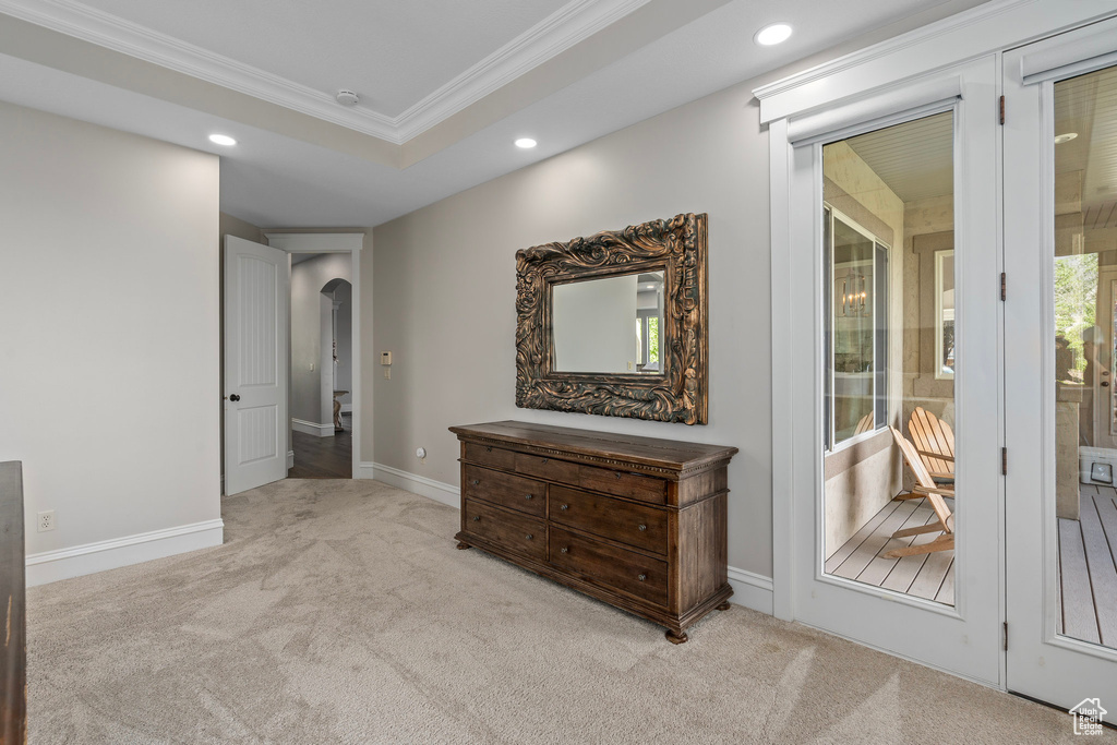 Bedroom with arched walkways, recessed lighting, crown molding, carpet floors, and baseboards