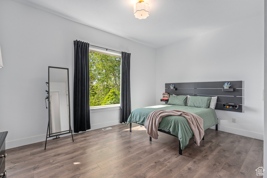 Bedroom featuring wood finished floors and baseboards