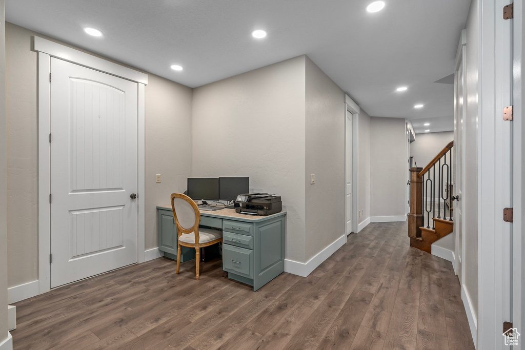 Office area with dark wood-style flooring, baseboards, and recessed lighting