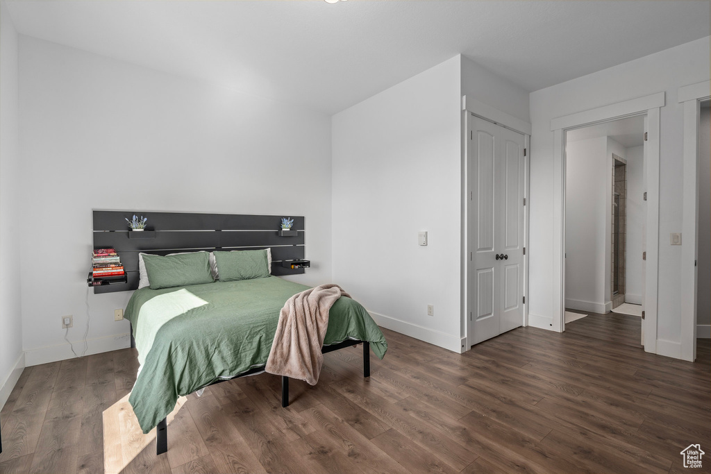 Bedroom with baseboards and wood finished floors