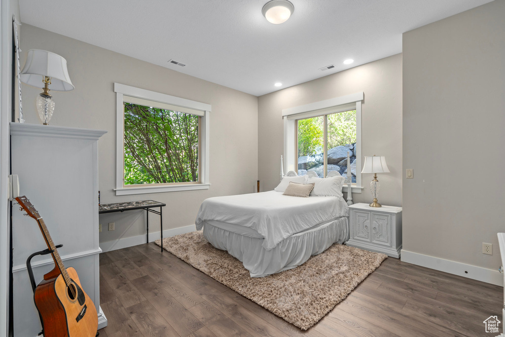 Bedroom featuring wood finished floors, baseboards, and recessed lighting