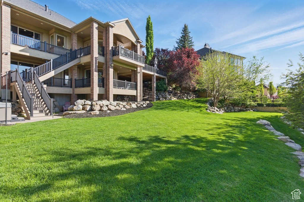 View of grassy yard with stairway