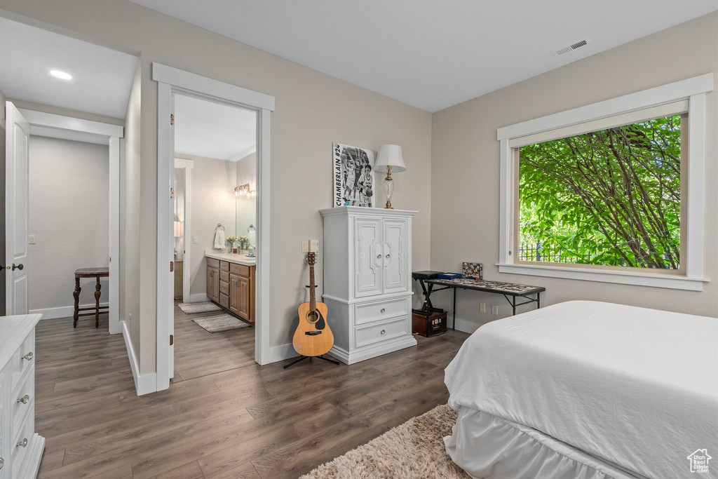 Bedroom featuring dark wood-style flooring, baseboards, and recessed lighting