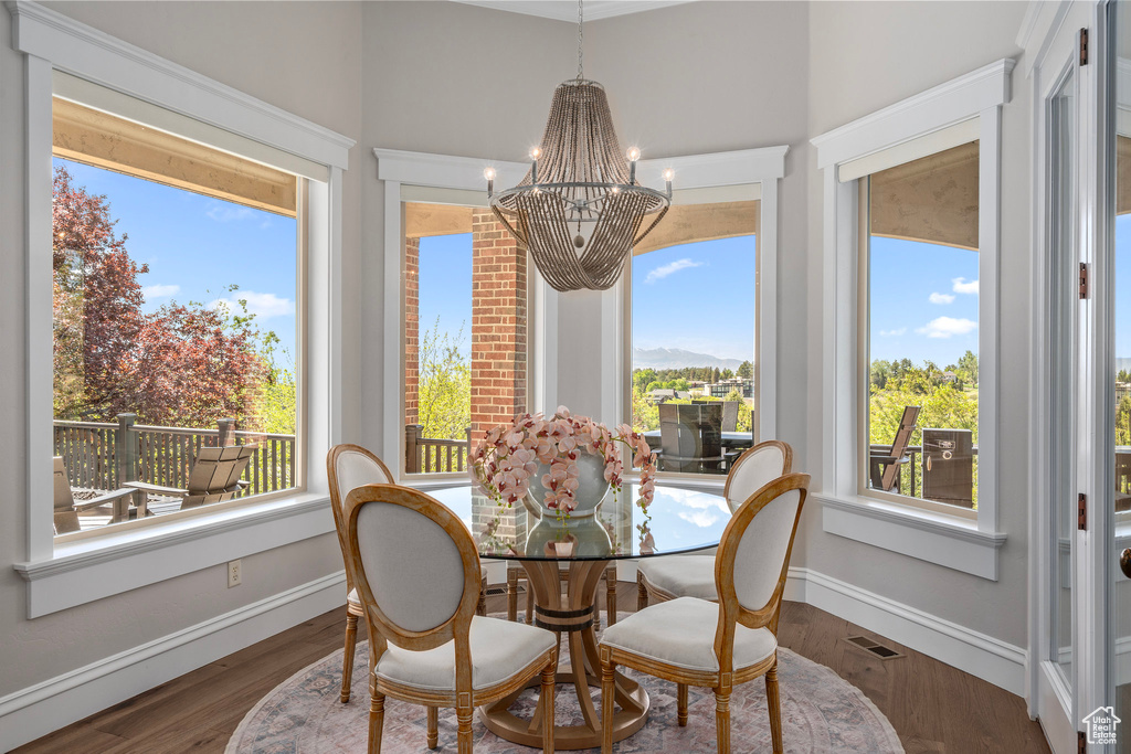 Dining room with a chandelier, baseboards, and wood finished floors