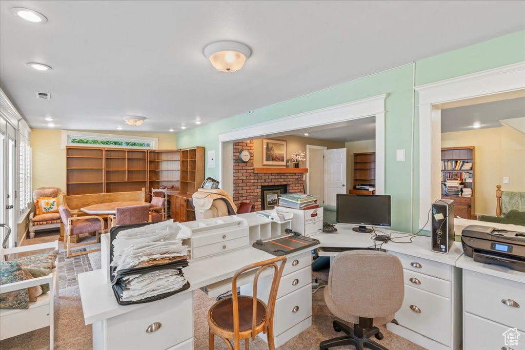 Office space featuring a brick fireplace and recessed lighting