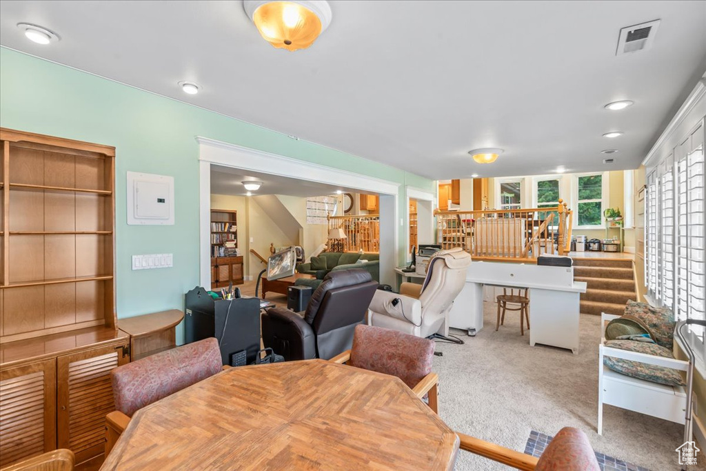 Carpeted dining area with stairs