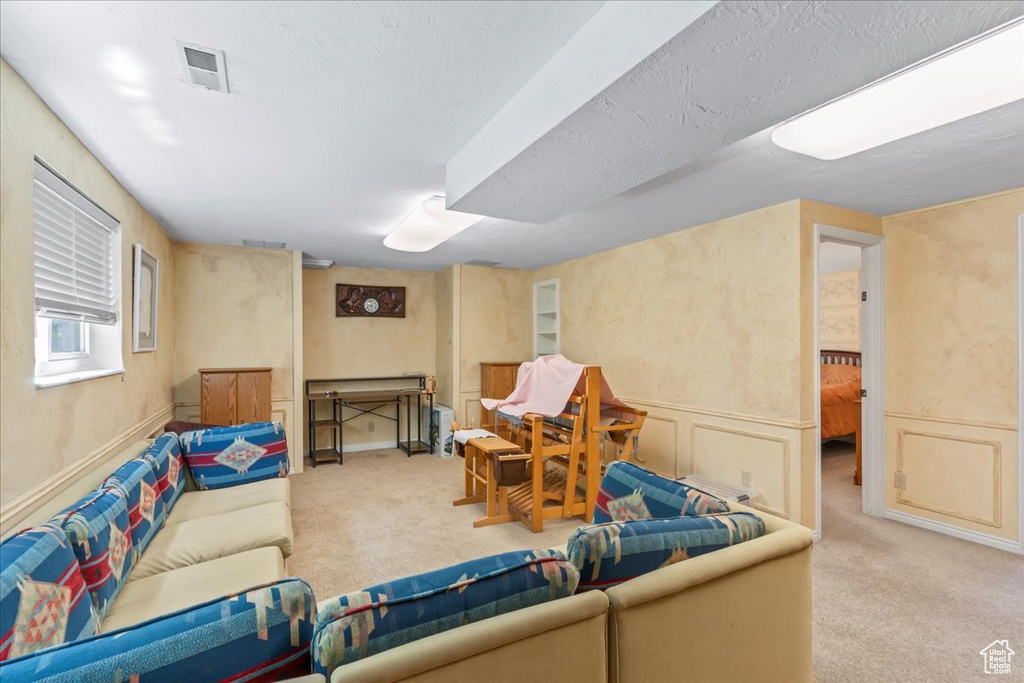 Living room with carpet flooring and a wainscoted wall