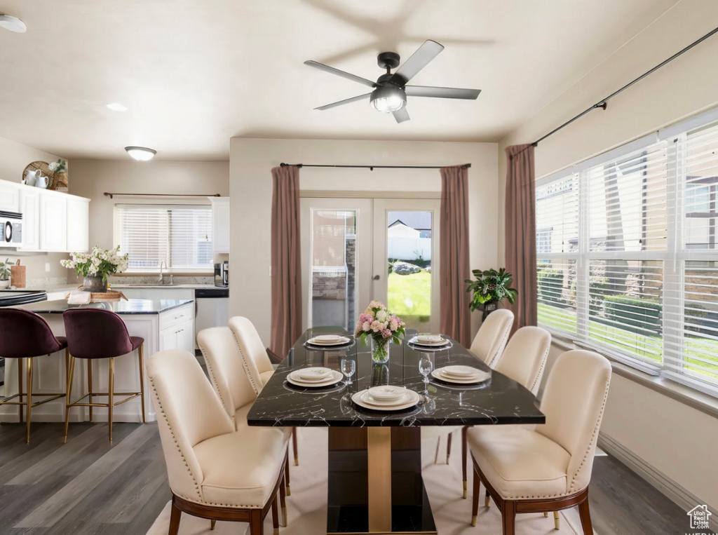 Dining room featuring a ceiling fan, french doors, and wood finished floors