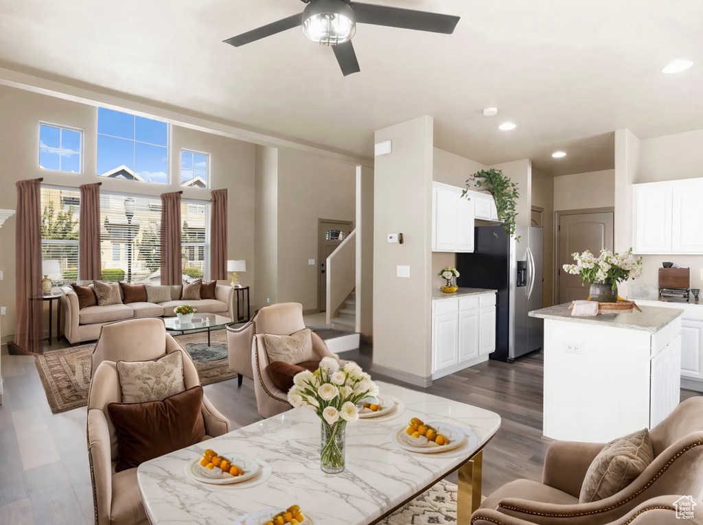 Living area featuring a ceiling fan, stairway, recessed lighting, and dark wood-type flooring