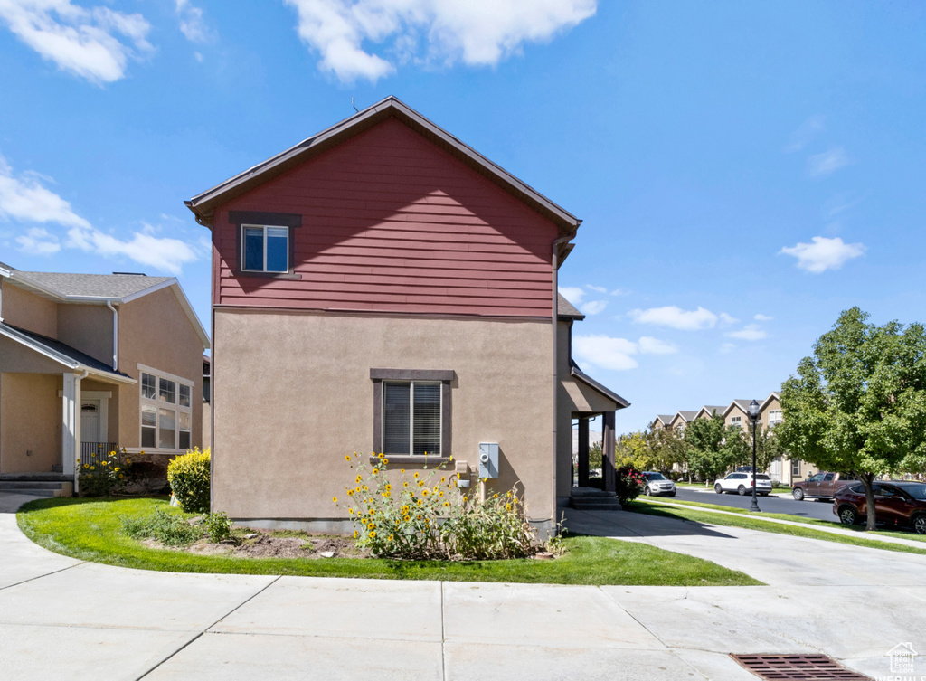 View of side of property with stucco siding and a residential view