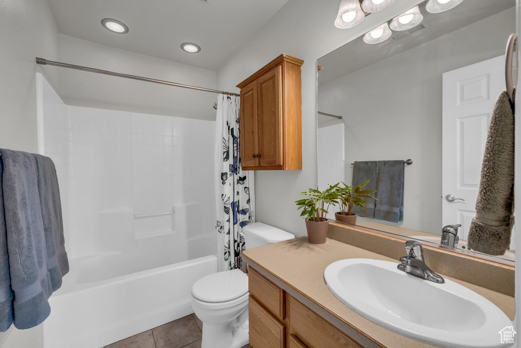 Full bathroom featuring toilet, tile patterned flooring, shower / bath combo, vanity, and recessed lighting