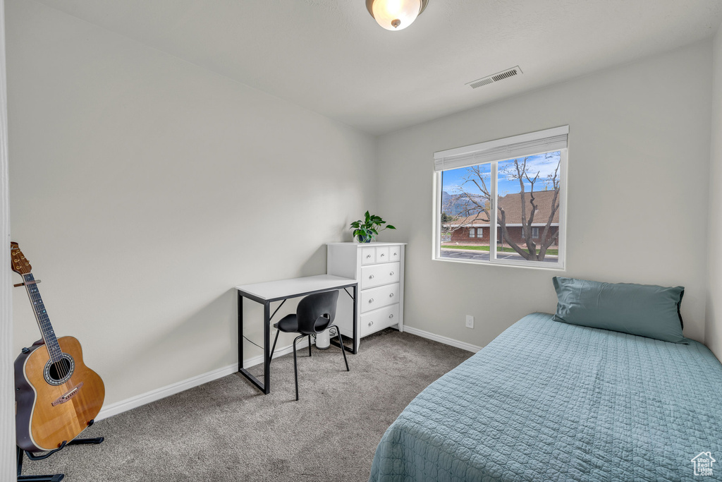 Carpeted bedroom with baseboards