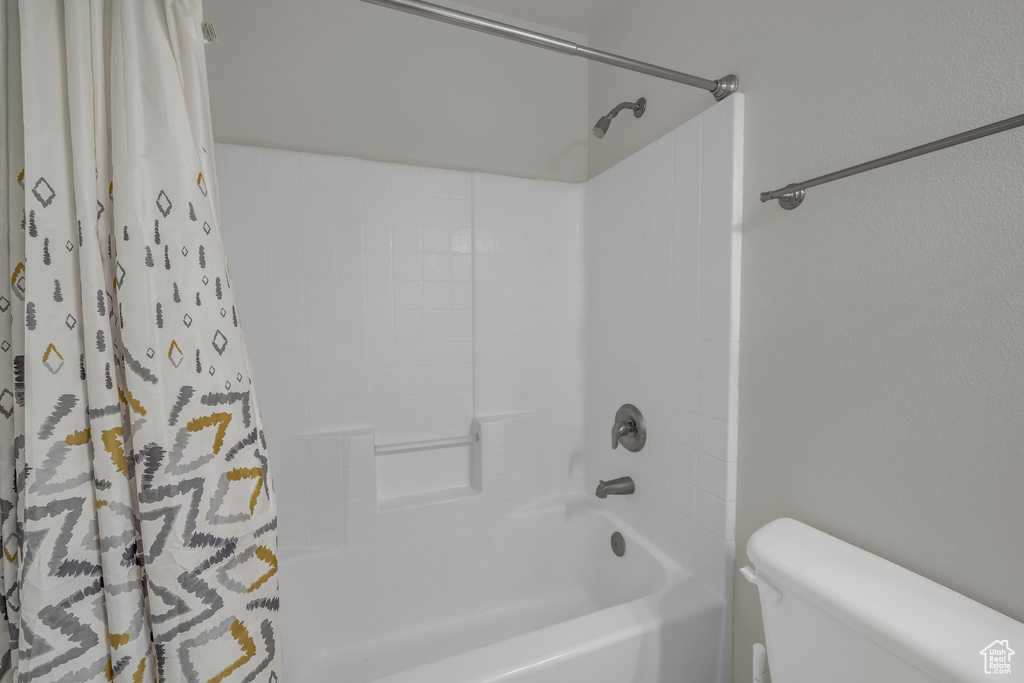 Bathroom with toilet and shower / bath combo