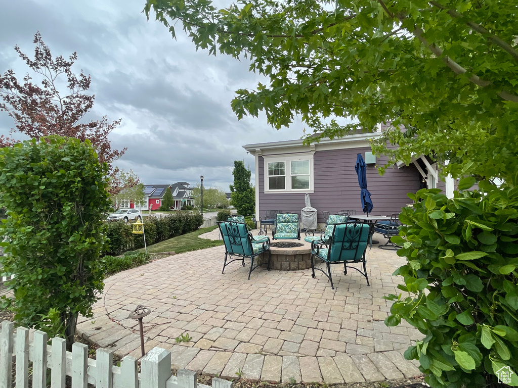 View of patio / terrace featuring a fire pit and fence