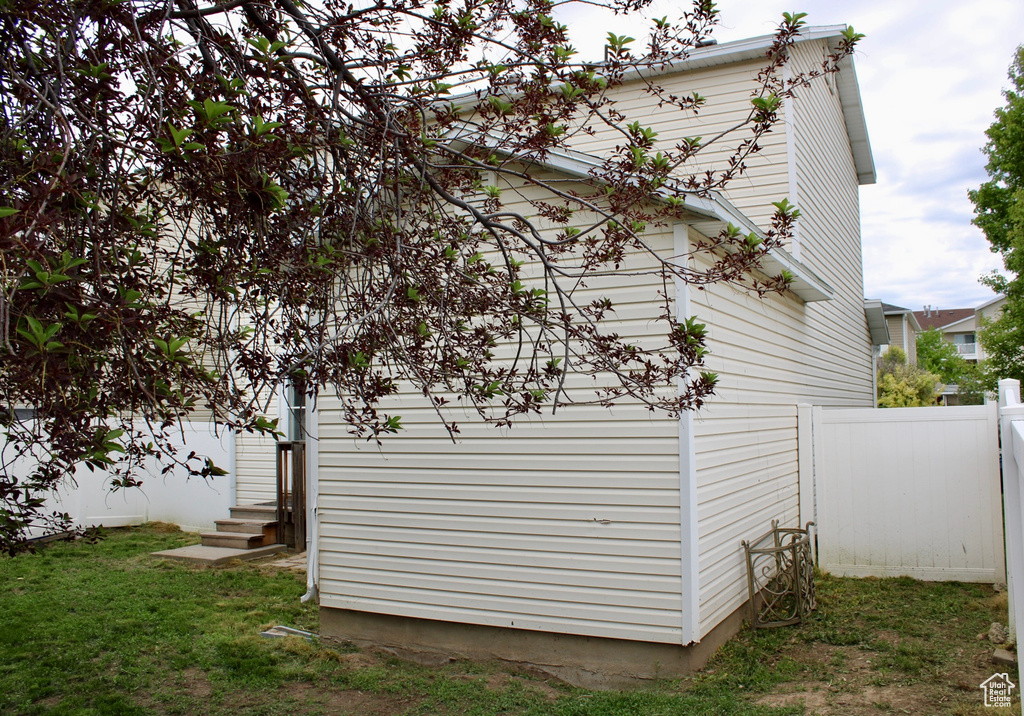 View of property exterior featuring fence