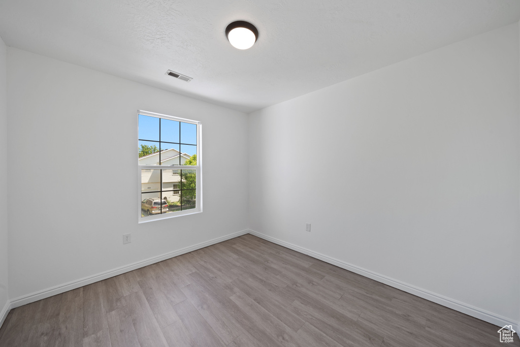 Spare room with wood finished floors and baseboards