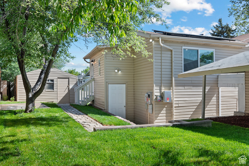 Rear view of property featuring a yard