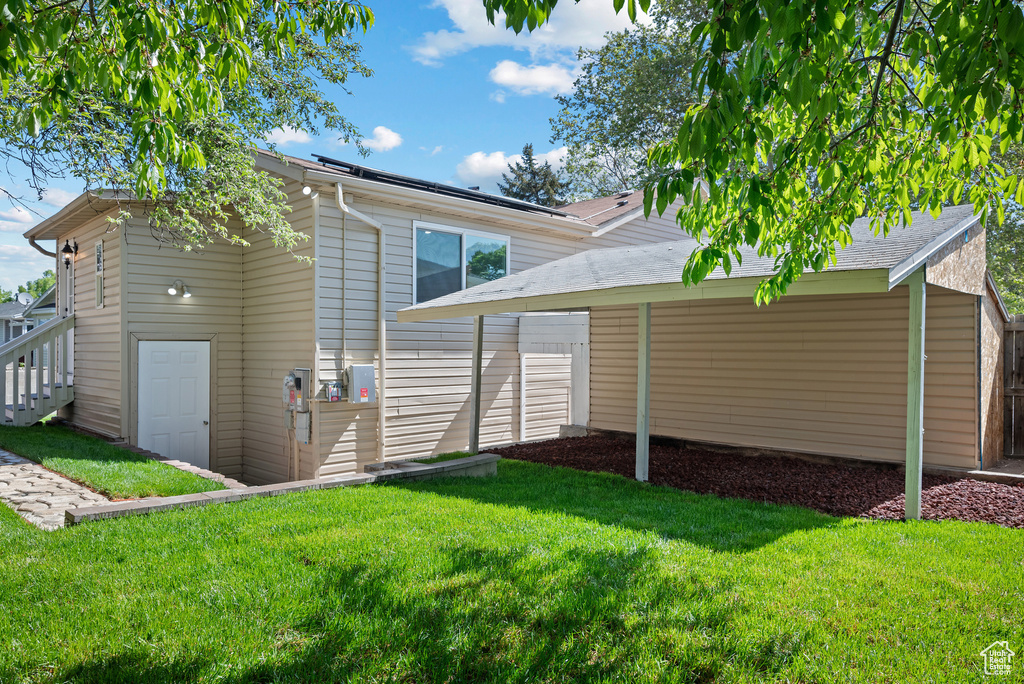 Rear view of property featuring a yard