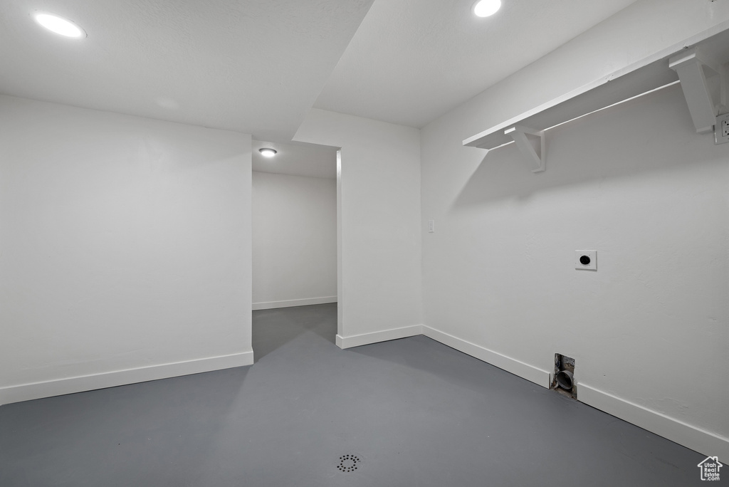 Laundry room with hookup for an electric dryer, baseboards, and recessed lighting