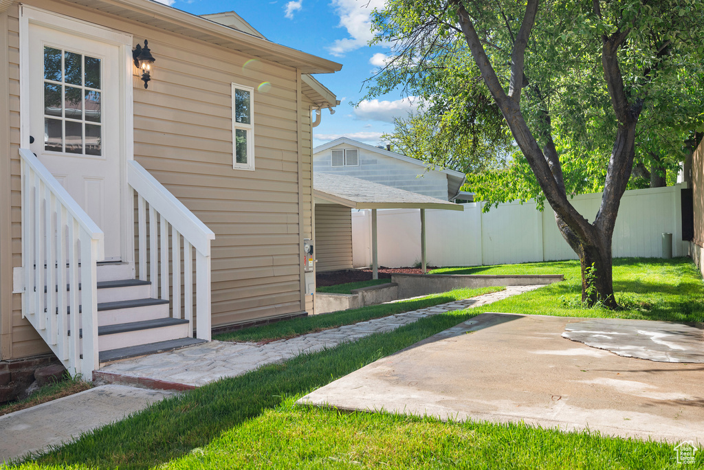 View of yard featuring fence and a patio