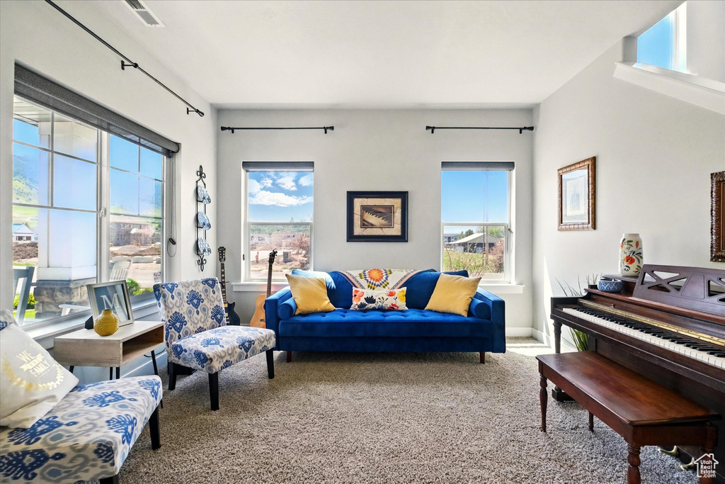 Living room featuring carpet and plenty of natural light