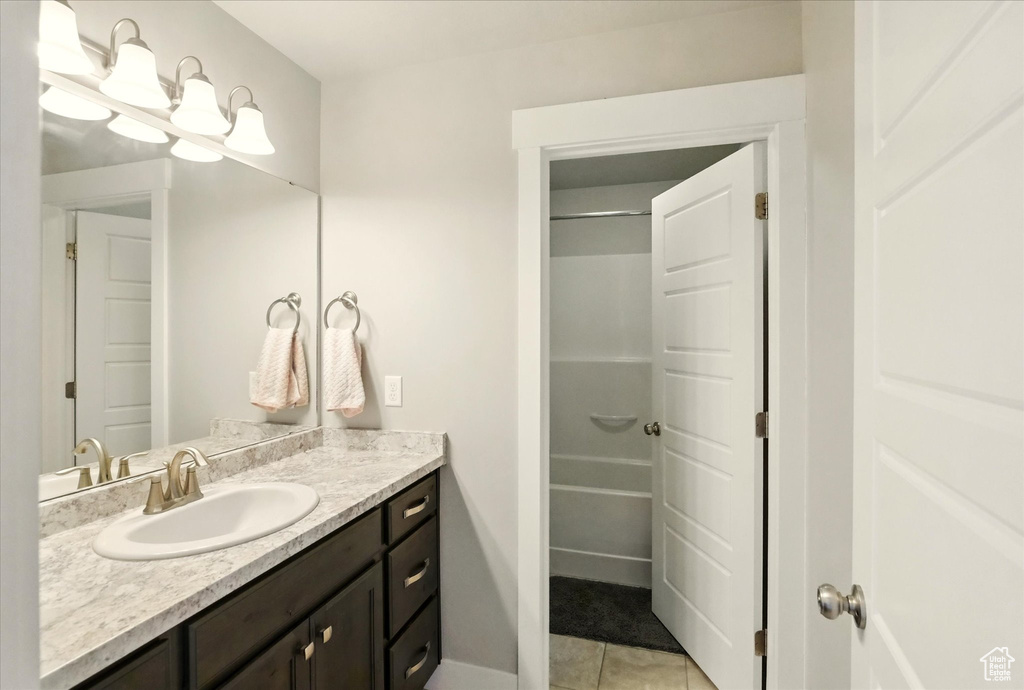 Full bath featuring vanity, tile patterned flooring, and a shower