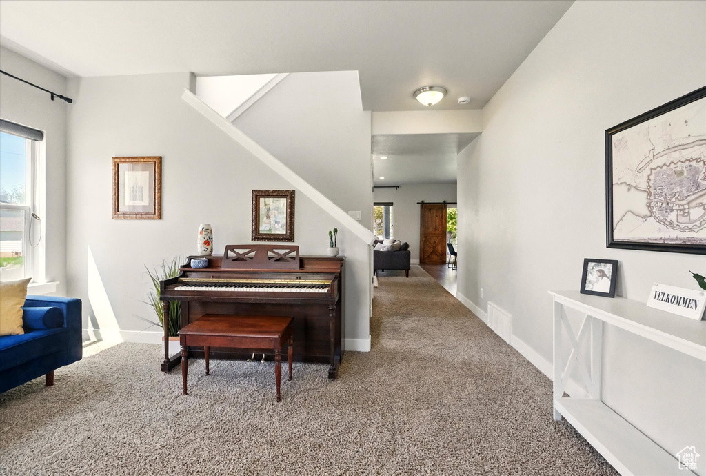 Sitting room with carpet floors and baseboards