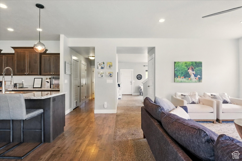 Living room featuring wood finished floors, recessed lighting, and baseboards
