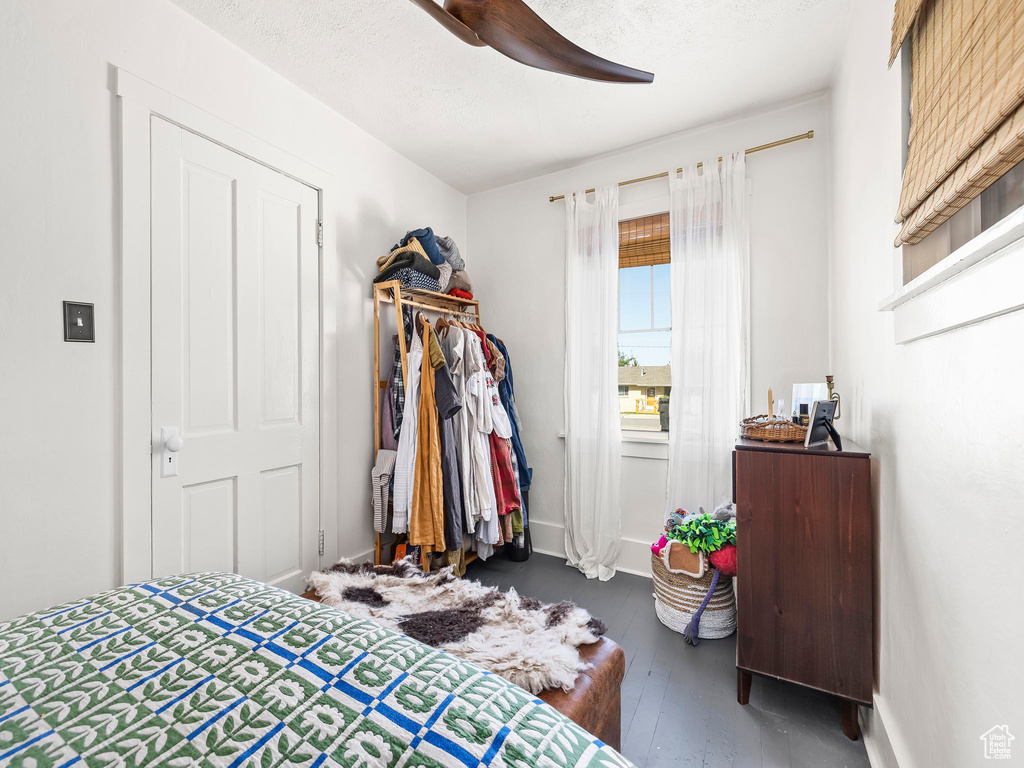 Bedroom featuring wood finished floors, a ceiling fan, and baseboards
