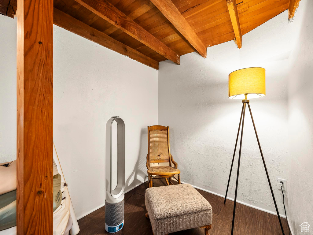 Living area with wooden ceiling, beam ceiling, and wood finished floors