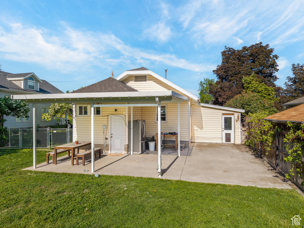 Back of property with a patio