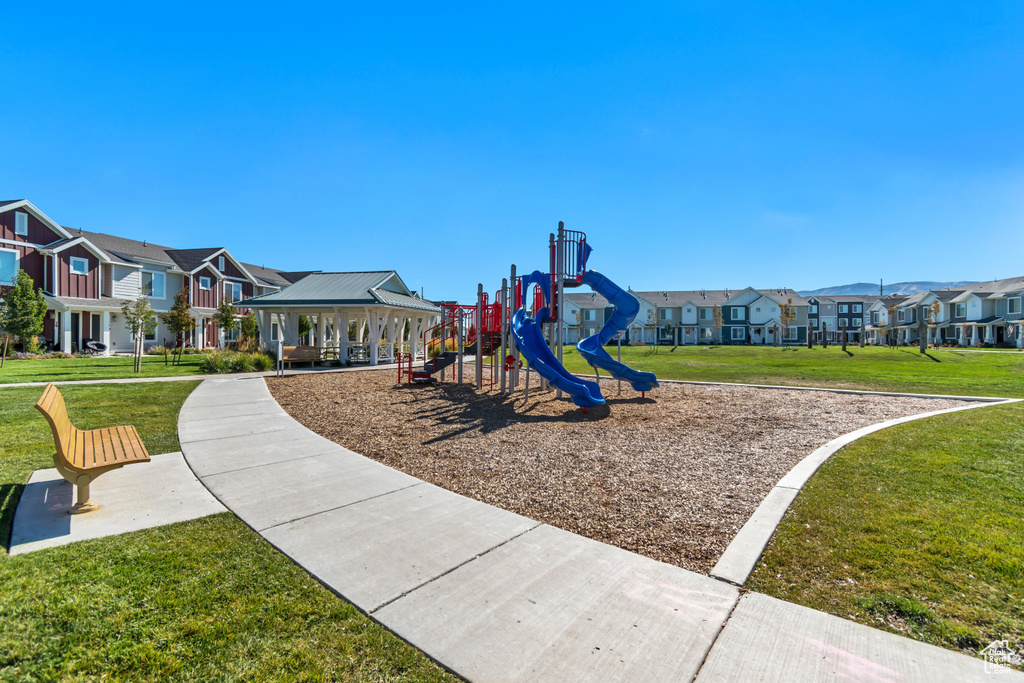 Communal playground with a residential view, a lawn, and a gazebo